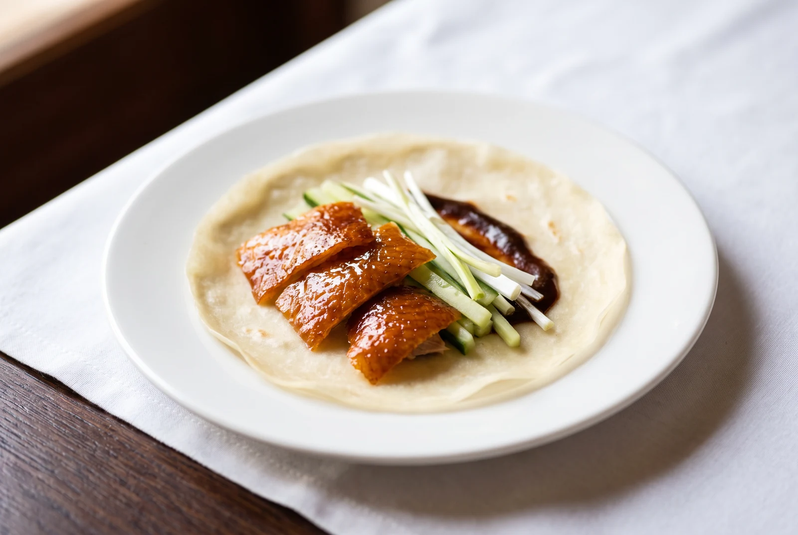 Duck skin, cucumber and spring onion on a thin pancake